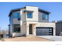 Striking modern two-story home with stone accents, gray siding, and a two-car garage at 2305 Glacier Ct, Lafayette, CO 80026