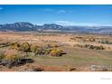 Picturesque aerial view of rolling land featuring expansive fields, distant mountains, and clear blue skies at 640 S 68Th St, Boulder, CO 80303