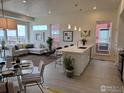 Open-concept living area boasts modern decor, island kitchen, large windows and views of the neighborhood at 733 Kubat Ln # B, Longmont, CO 80503