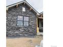 Closer view of stone exterior accent and window at 1366 Eliza Ave, Berthoud, CO 80513