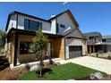 Two-story home featuring a sleek exterior with a modern design, complemented by professionally landscaped front yard at 923 Saint Andrews Ln, Louisville, CO 80027