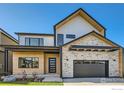 Beautiful two-story home boasts a sleek exterior with a modern design and a two-car garage at 923 Saint Andrews Ln, Louisville, CO 80027