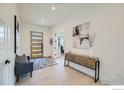 Inviting home foyer featuring a stylish console table, modern décor, and hardwood floors at 923 Saint Andrews Ln, Louisville, CO 80027