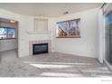 Bright living room features a corner fireplace, a large window, and sliding glass doors at 2850 Aurora Ave # 112, Boulder, CO 80303