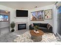 Cozy living room boasts a fireplace, large window, and neutral decor at 2850 Aurora Ave # 112, Boulder, CO 80303