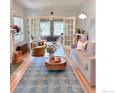 Inviting living room featuring a stylish rug, decorative fireplace, and seamless transition into an office at 1515 E 8Th Ave # 1, Denver, CO 80218