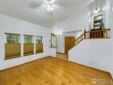 Bright living room featuring hardwood floors, many windows, and staircase access at 2720 E 121St Pl, Thornton, CO 80241