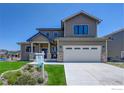 Two-story home with a gray exterior, landscaped lawn, and two-car garage at 958 Eldorado Ln, Louisville, CO 80027