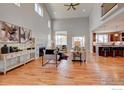 Open living room with hardwood floors, high ceilings, and kitchen views at 958 Eldorado Ln, Louisville, CO 80027