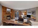 Relaxing living room features a wood-burning fireplace, bar seating, and a view into the main bedroom at 2962 Shadow Creek Dr # 109, Boulder, CO 80303