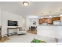 Open concept living area with kitchen and dining space, modern light fixtures, and comfortable seating at 665 Manhattan Dr # 5, Boulder, CO 80303