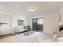 Bright living room with sliding glass doors to the balcony, carpeted floors, and modern furnishings at 665 Manhattan Dr # 5, Boulder, CO 80303