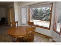 Bright dining area with round table and large window overlooking backyard at 1633 Francis Way, Longmont, CO 80501