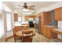 Kitchen features wood cabinets, stainless steel appliances, and a breakfast nook at 1633 Francis Way, Longmont, CO 80501