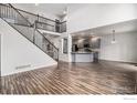 Open concept living room with kitchen and staircase views at 6850 Sage Ave, Firestone, CO 80504