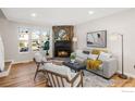 Cozy living room with a stone fireplace and hardwood floors at 18234 E Arizona Ave # D, Aurora, CO 80017