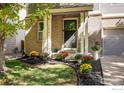 Beautiful home exterior showcasing well-kept landscaping, fresh flowers, and a welcoming entrance at 3674 Dexter St, Denver, CO 80207