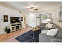 Comfortable living room with a plush sectional sofa, decorative rug, and ample natural light at 3674 Dexter St, Denver, CO 80207