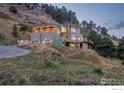 Beautiful hillside home with manicured lawn, private drive, and modern exterior at 230 S Cedar Brook Rd, Boulder, CO 80304