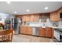 Well-maintained kitchen boasting wooden cabinets, stainless steel appliances, and a convenient wine rack at 1226 Atwood St, Longmont, CO 80501