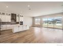 Bright, open-concept kitchen with a large island, modern appliances, and sliding glass doors to the yard at 3015 Newfound Lake Rd, Berthoud, CO 80513
