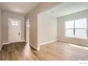 Inviting living room showcasing hardwood floors and a large window for natural light, creating an open space at 3015 Newfound Lake Rd, Berthoud, CO 80513