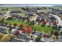 Aerial view of a community with lake and autumn trees at 1463 Moonlight Dr, Longmont, CO 80504