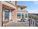 Home exterior showcasing entryway and deck with mountain views at 6057 Red Hill Rd, Boulder, CO 80302