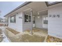 Exterior view of covered front porch with numbers marking the home's street address at 224 N 2Nd St, Berthoud, CO 80513