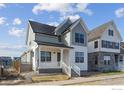 Two-story craftsman style home with gray and white exterior, front porch, and landscaping at 154 Westerly Blvd, Erie, CO 80516