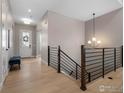 Bright entryway with hardwood floors and a modern staircase at 1425 Burt Ave, Berthoud, CO 80513