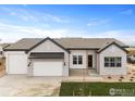 Craftsman style home with white brick exterior and a two-car garage at 1425 Burt Ave, Berthoud, CO 80513