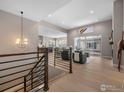 Open concept living room with hardwood floors and sliding glass doors at 1425 Burt Ave, Berthoud, CO 80513