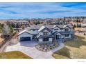 Expansive aerial view of a stunning house, showcasing its well-maintained landscaping and spacious driveway at 9258 Niwot Hills Dr, Niwot, CO 80503