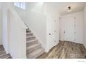Bright entryway with staircase, neutral flooring, and access to interior rooms at 12718 Bend Ct, Firestone, CO 80504
