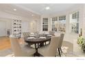 Formal dining room with a large table and hardwood floors at 704 Windflower Dr, Longmont, CO 80504