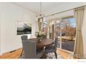 Bright dining room with a wooden table and access to a patio at 704 Windflower Dr, Longmont, CO 80504