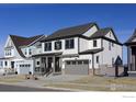 Beautiful two-story home featuring a covered porch and a gray two-car garage at 1571 Poplar Dr, Erie, CO 80516