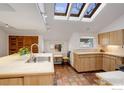 Well-lit kitchen with skylights, light wood cabinets, and tile flooring at 2238 15Th St, Boulder, CO 80302