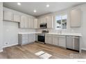 Modern kitchen with stainless steel appliances, ample countertop space, and gray cabinetry at 2277 Serenidad St, Brighton, CO 80601