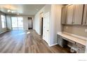 Bright and spacious living room with wood-look flooring and ample natural light at 2277 Serenidad St, Brighton, CO 80601