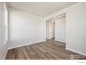 Spacious living room featuring hardwood floors, neutral walls, and an open layout at 2277 Serenidad St, Brighton, CO 80601