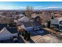 Residential aerial featuring a single-story home with mountain views and well-kept yards at 3557 Settler Ridge Dr, Mead, CO 80542