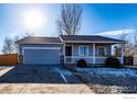 Gray ranch-style home with a two-car garage and landscaping at 3557 Settler Ridge Dr, Mead, CO 80542