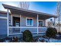 House exterior showcasing a covered porch with white railings at 3557 Settler Ridge Dr, Mead, CO 80542