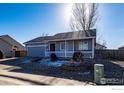 Attractive single-story home with a covered front porch, low-maintenance landscaping, and attached garage at 3557 Settler Ridge Dr, Mead, CO 80542