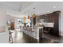 Open concept kitchen featuring dark cabinetry and an island at 4692 Clear Creek Dr, Firestone, CO 80504