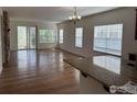 Open concept living room with hardwood floors, many windows, and stone fireplace at 1435 Rustic Dr, Longmont, CO 80504
