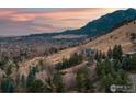 Aerial view showcasing the home's hillside location and surrounding mountain views at 230 Cactus Ct, Boulder, CO 80304