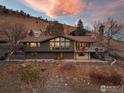 Stunning exterior view showcasing a modern home nestled against a picturesque mountain at twilight at 230 Cactus Ct, Boulder, CO 80304